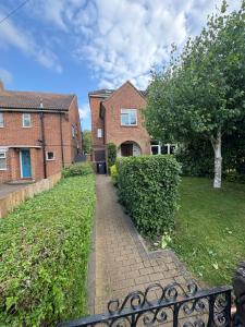 a brick house with a walkway in a yard at Fairfield Large 4 Bed Log Fire in Isham +17 photos