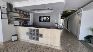 a bar in a building with a sign on the wall at Hotel Costa Caribe Barranquilla in Barranquilla