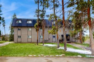 a large house with trees in front of it at Hi Country Haus Hideaway in Winter Park
