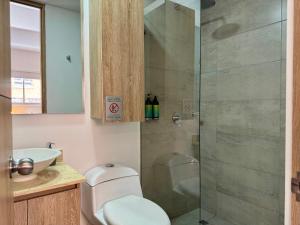 a bathroom with a shower with a toilet and a sink at Cozy Loft in 93 park in Bogotá