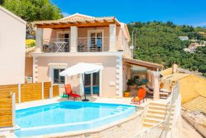 a villa with a swimming pool and a house at Villa Frosso in Kalami