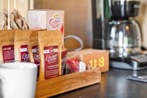 a cup of coffee sitting on a counter next to a table at Eden Reserve Glamping Tents - All 8 Tents in Williamstown