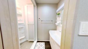 a white bathroom with a sink and a toilet at Hotel Yado SK Shinkoiwa - Vacation STAY 17543v in Tokyo