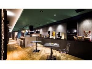 a restaurant with a bar with chairs and a table at HOTEL Noir Blanc - Vacation STAY 18104v in Shizuoka