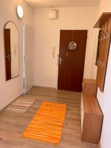 a hallway with a door and a rug on the floor at Cozy apartment - Excellent location in Piešťany