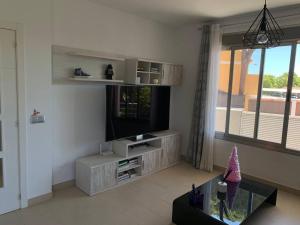 a living room with a flat screen tv and a fish tank at Villa Serena near the beach in Mijas Costa