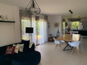 a living room with a couch and a wooden table at Villa Serena near the beach in Mijas Costa