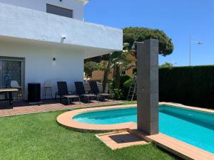 a swimming pool in the backyard of a house at Villa Serena near the beach in Mijas Costa