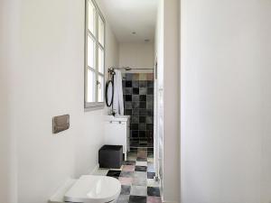 a bathroom with a toilet and a tile floor at Villa du Littoral in Grimaud +26 photos