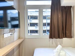 Ένα ή περισσότερα κρεβάτια σε δωμάτιο στο Nest Hotel Singapore