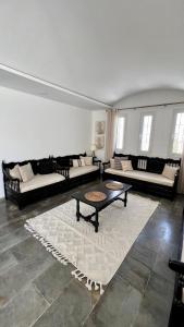 a large living room with couches and a table at Villa Le Domaine Djerba Piscine Chauffée sans vis à vis in Mezraya