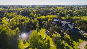 an aerial view of a large house in a forest at HOTEL KOZI GRÓD Pokoje i Domki na Kaszubach in Pomlewo
