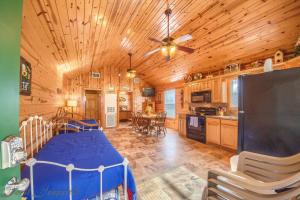 a bedroom with a bed and a kitchen in a cabin at RR 9122SF Sunflower Cabin in Canyon Lake +16 photos