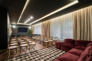 a room with a room with tables and chairs at Eurostars Matera La Suite in Matera