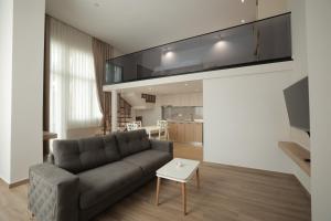 a living room with a couch and a table at Duplex City in Durrës