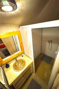 a small bathroom with a sink and a shower at Sahara Luxe Camp in Merzouga +60 photos