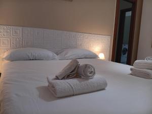 a bedroom with a bed with towels on it at Casa Girasole in Bellinzago Lombardo