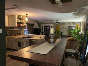a kitchen with a large wooden table in a room at Quaint & Vivacious Room-Queen in Kyle