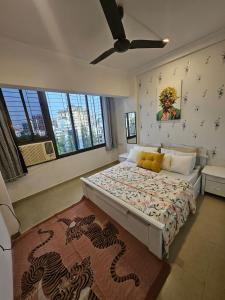 a bedroom with a large bed with a dragon print on the wall at The SkyLoft Bandra Modern 1BHKwith PaidParking in Mumbai