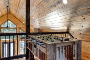 a wooden room with a foosball table at Cozy Luxe Cabin Hot Tub Firepit in Broken Bow