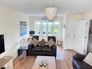 a living room with a couch and a table at Paddys Corner in Filey