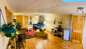a living room with a blue couch and a kitchen at Country Roads Dwelling in Hamilton +5 photos