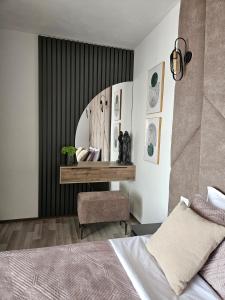 a bedroom with a bed and a table with a chair at Luxury Penthouse with Private Jacuzzi & Sea View in Durrës