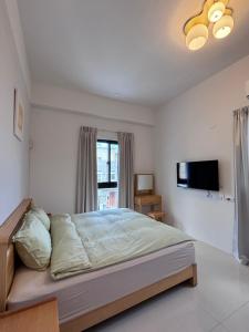 Postel nebo postele na pokoji v ubytování Guangmei's home 台東縣民宿第2101號