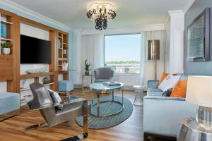 a living room with a couch and a table at Renaissance Charlotte SouthPark Hotel in Charlotte