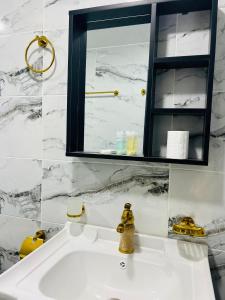 a white bathroom with a sink and a mirror at Whispering Rum in Wadi Rum +43 photos
