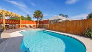 una piscina in un cortile con recinzione in legno di Guilty Treasure a Panama City Beach