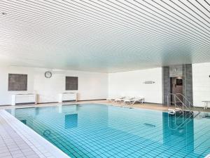 a large swimming pool with a blue tile floor at Peak11 Fewo- Panorama View Lahnstein Pool & Sauna in Lahnstein