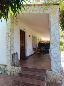 an open door to a patio with a table at House in Garden in Palermo