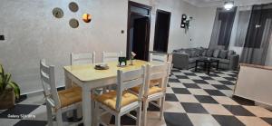 a dining table and chairs in a living room at Dar Tetuan 4 You II in Tétouan