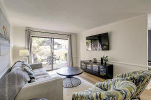 a living room with a couch and chairs and a tv at Shops Restaurants Close King Queen Double Beach Gear and Bike Rentals Included in Hilton Head Island