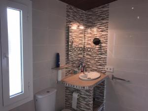 un bagno con lavandino e WC di Tranquil House Perfect for Vacations a Platja  d'Aro Altre 24 foto