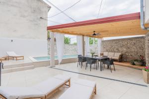 an outdoor patio with a table and chairs at Villa Marisan in Bribir