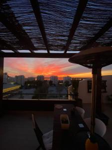 a living room with a view of a sunset at Algarve Apartment, Faro - Excellent Location in Faro