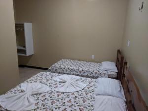Ένα ή περισσότερα κρεβάτια σε δωμάτιο στο Pousada Paraíso