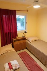 a bedroom with two beds and a window at Departamento a 5 min del Centro in Posadas