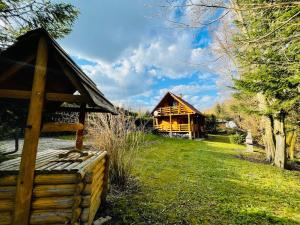 a log cabin with a bench in front of it at Szmer Soliny in Werlas