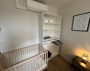 a room with a white closet with shoes in it at Gîte Cosy - 90m2 - T4 - Climatisé - Tout équipé in Retournac +28 photos