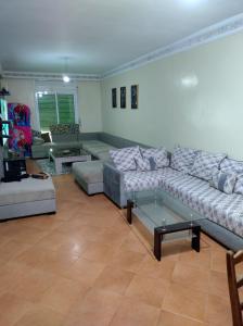 a living room with a couch and a table at AZEMMOUR appart in Azemmour