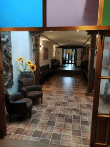 a view of a hallway with chairs and a table at El Sueño De Lucrecia in Villarrubia de Santiago
