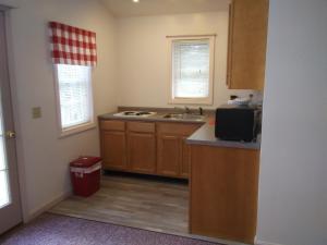 an empty kitchen with a sink and a counter at Mcleod Cottage in Norway