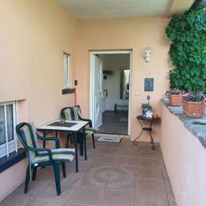 a patio with two chairs and a table and a table at Ferienwohnung Haus Bleser in Cochem
