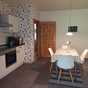 a kitchen with a table and chairs in a kitchen at Ferienwohnung Haus Bleser in Cochem +11 photos