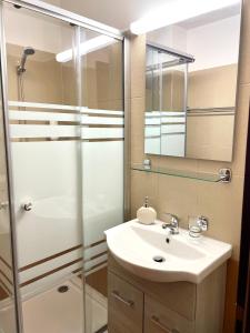 a bathroom with a sink and a shower at Almir Bran in Bran +81 photos