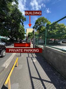 a parking lot with a building and parachute parking at Matavai Two in Papeete