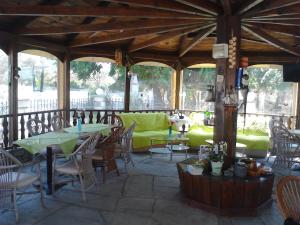 a pavilion with tables and chairs on a patio at Patra Rooms Skala Prinou in Prinos